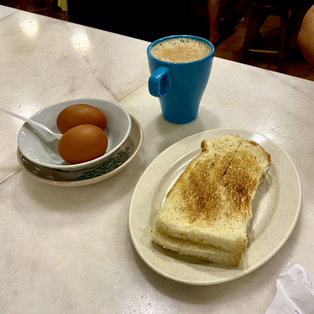 Toast, soft-boiled eggs and coffee on a marble table at Village Park