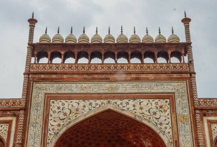 Red sandstone gateway arch at the Taj Mahal complex in Agra
