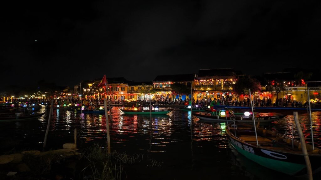 Hoi An riverfront lit up at night with boats on the Thu Bon River