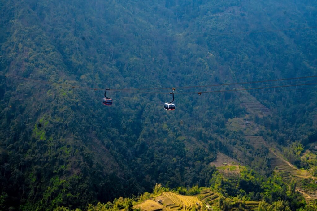 Cable cars crossing a green valley near Sapa, Vietnam