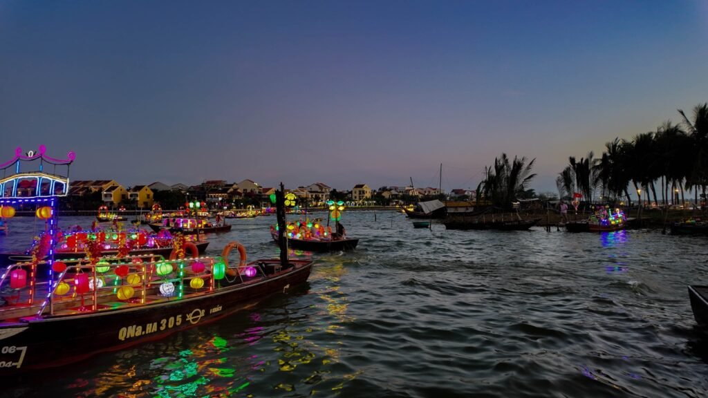 Colourful lantern boats on the Thu Bon River at dusk in Hoi An, Vietnam