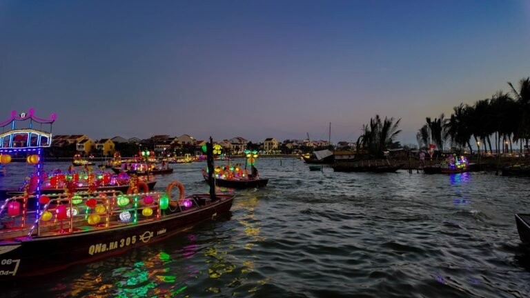 Colourful lantern boats on the Thu Bon River at dusk in Hoi An, Vietnam